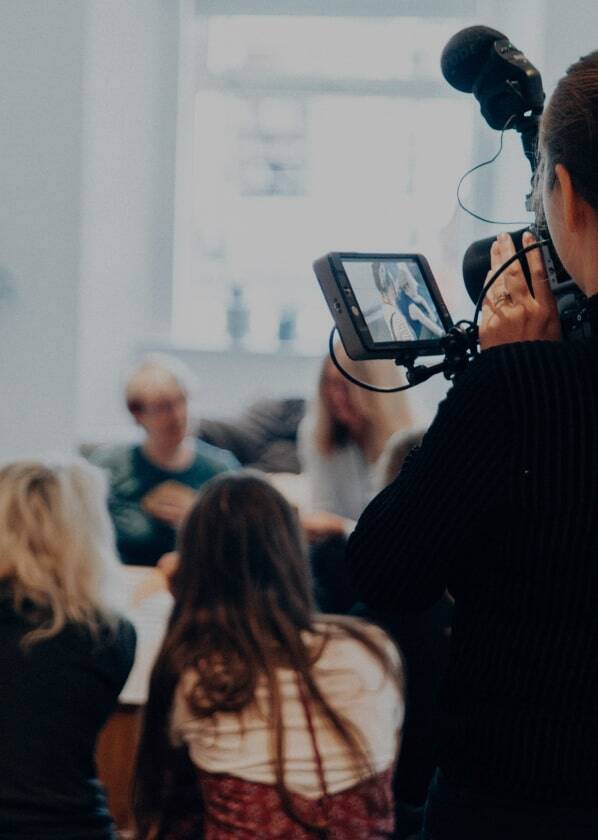 Person filming group of people