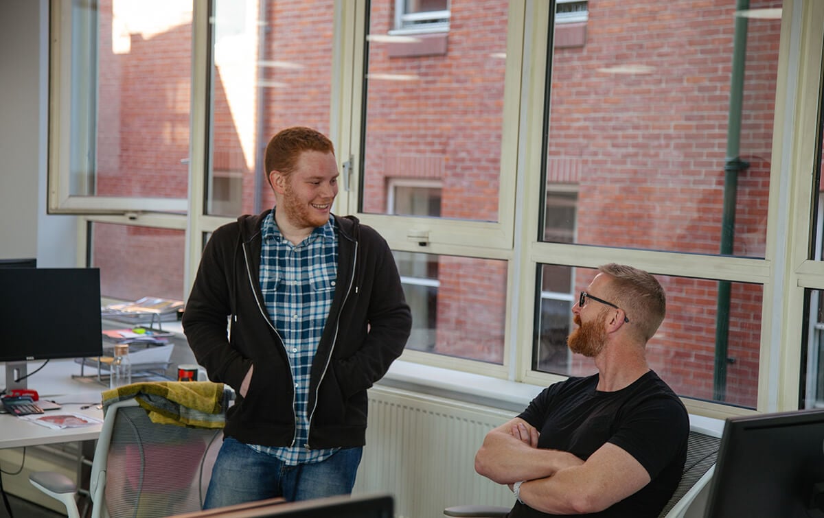 Coworkers talking in office